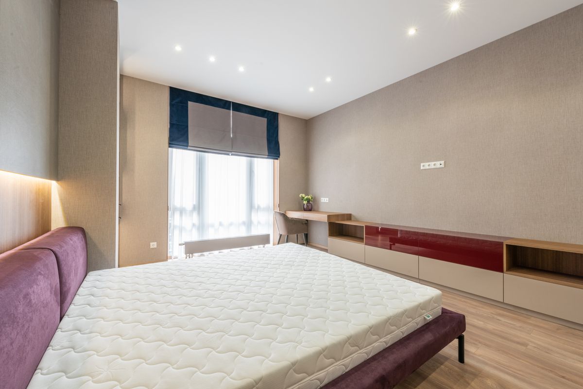 A white mattress in a calm, modern bedroom