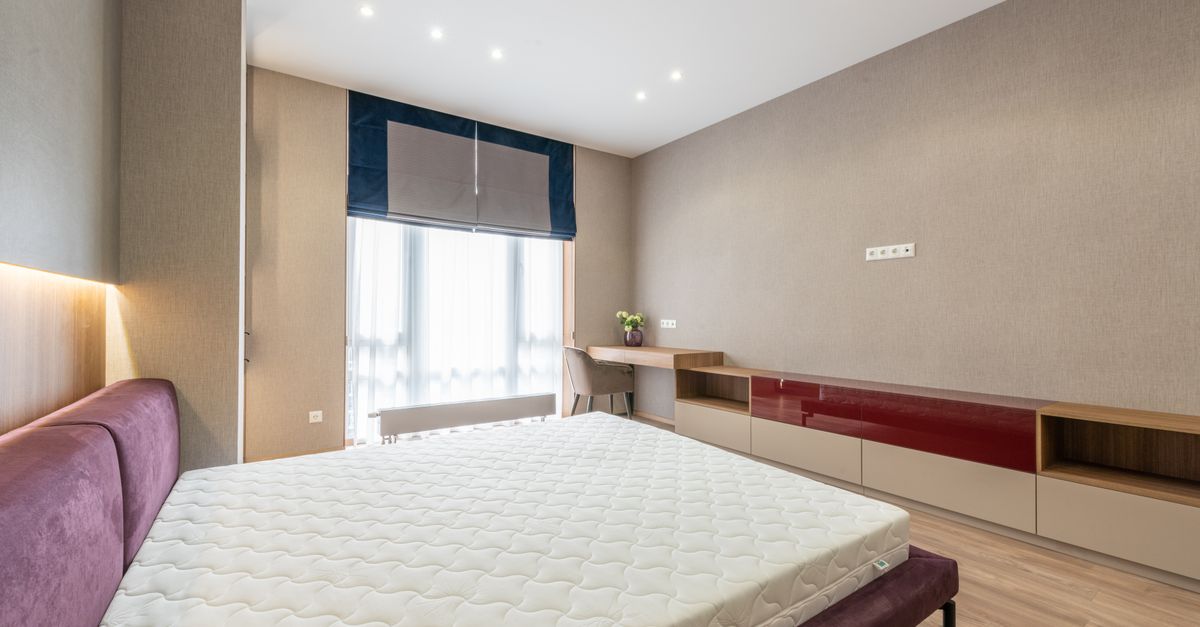 A white mattress in a calm, modern bedroom